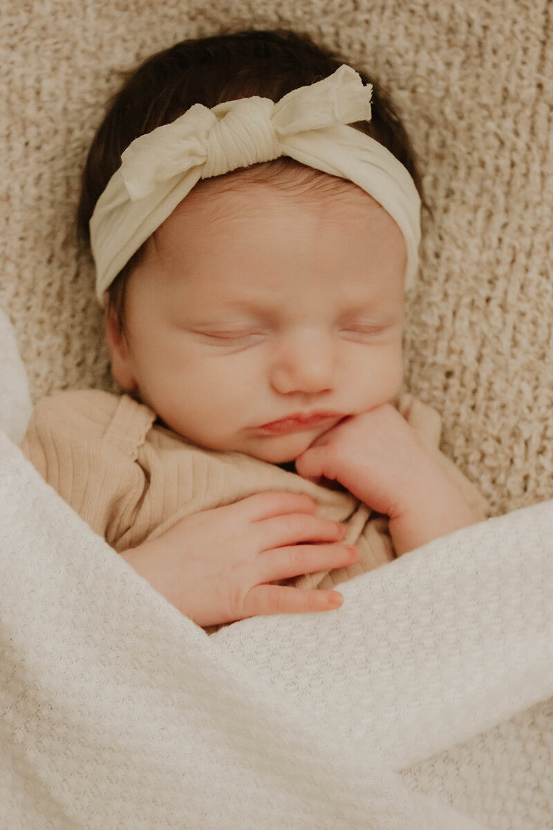 girl newborn with bow