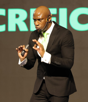 Keynote speaker, Brendan James Kane speaking on stage at an event