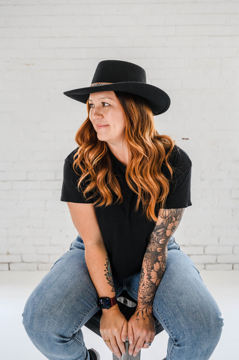 Denver Wedding Photographer captures woman sitting on stool during photo headshots