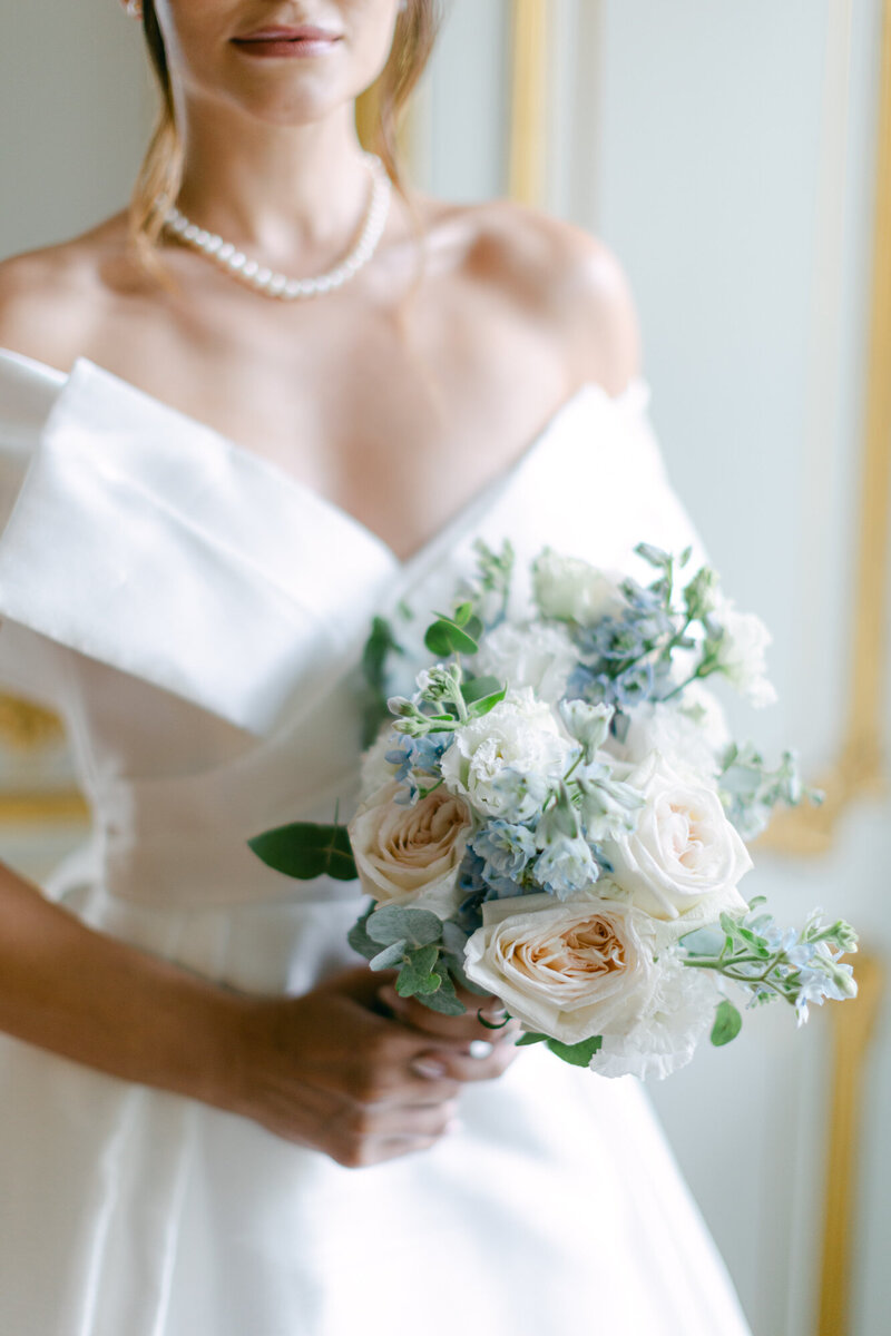 Bride holding her elegant blush and blue wedding bouquet at majestic palace Coburg in Vienna designed by ECLAT Destination Weddings