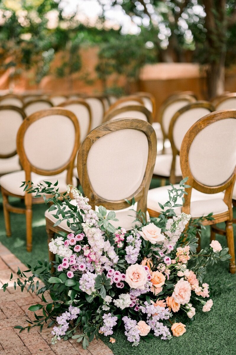 Ceremony chairs with romantic floral arrangements - wedding photographer Scottsdale AZ.