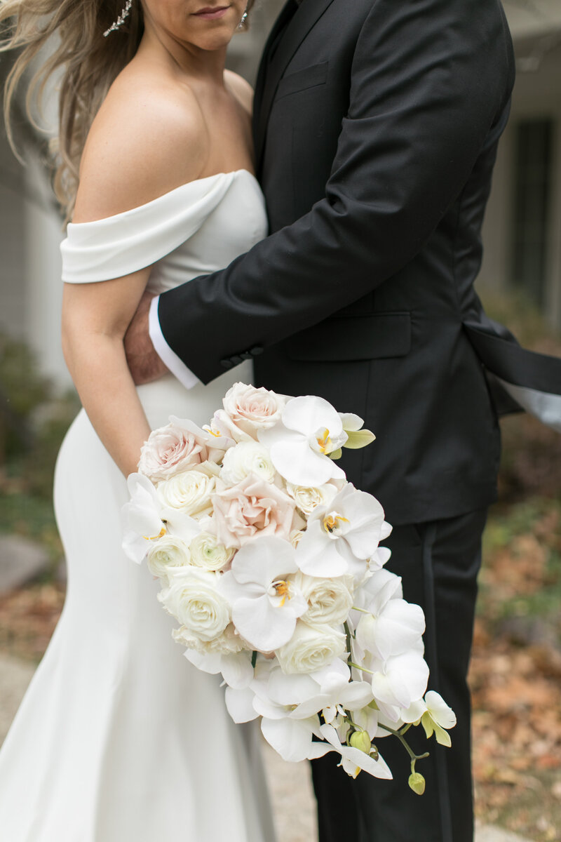 Bride and groom with white and pink bouquet.