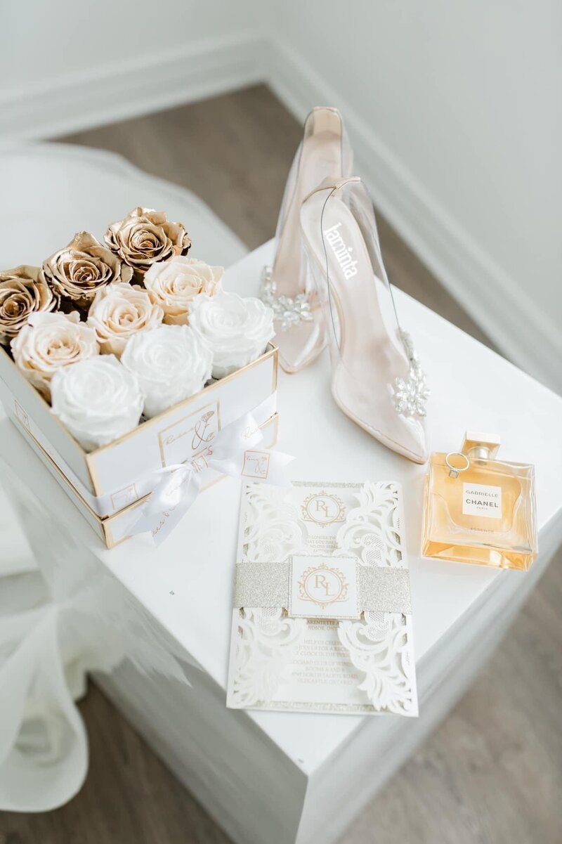delicate wedding invitation, high heels, roses, and chanel perfume