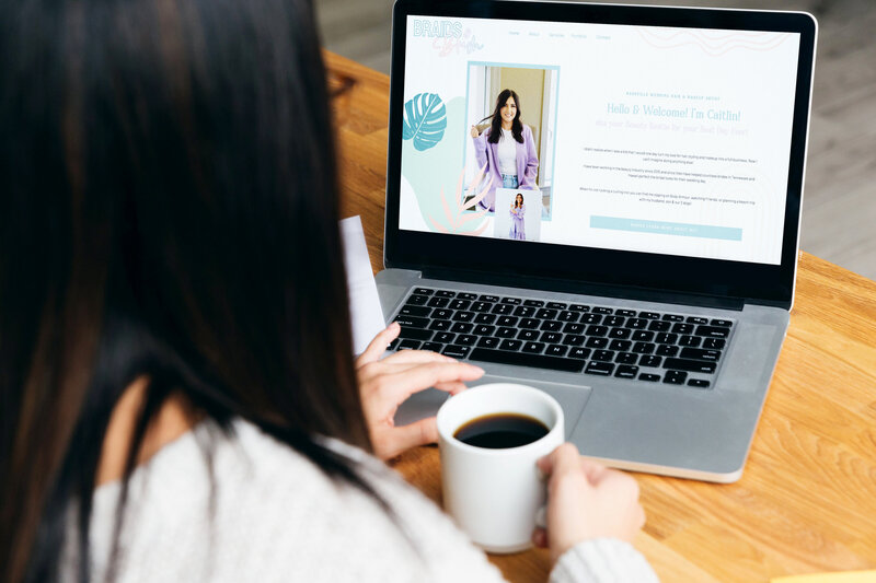 Woman drinking coffee and scrolling a wddding hairstylist new website