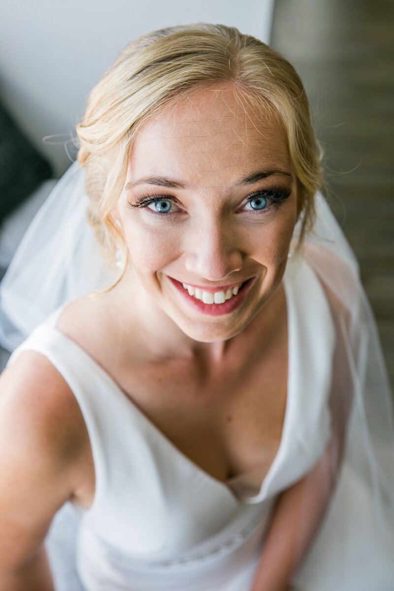 Bride looking at camera with veil | Taken at Grace on the Lake Wedding in Maine