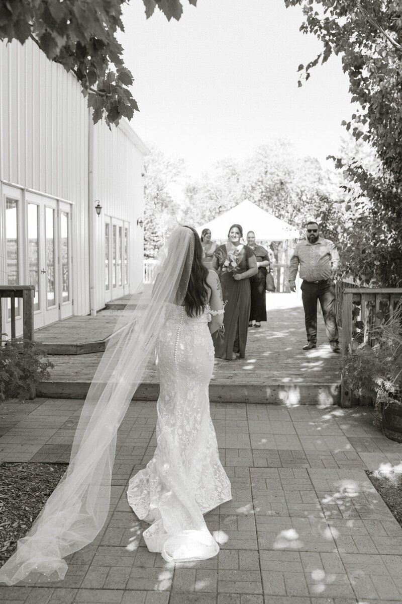 Bride walking to meet her guests at the Gates On Roblin 