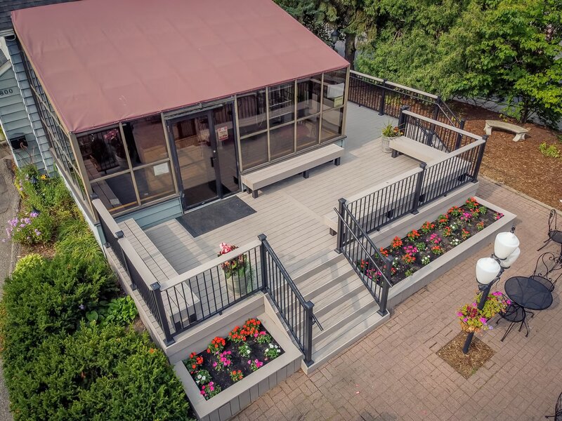 Aerial view of Adele's Frozen Custard with a low-maintenance deck and coordinating integrated planters at ground level along the front side. 