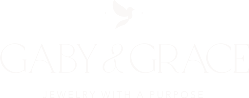 Gaby & Grace’s full primary logo in a ballet slipper on a rose tone background, featuring the dove icon above the elegant serif wordmark and tagline “Jewelry with a Purpose.”