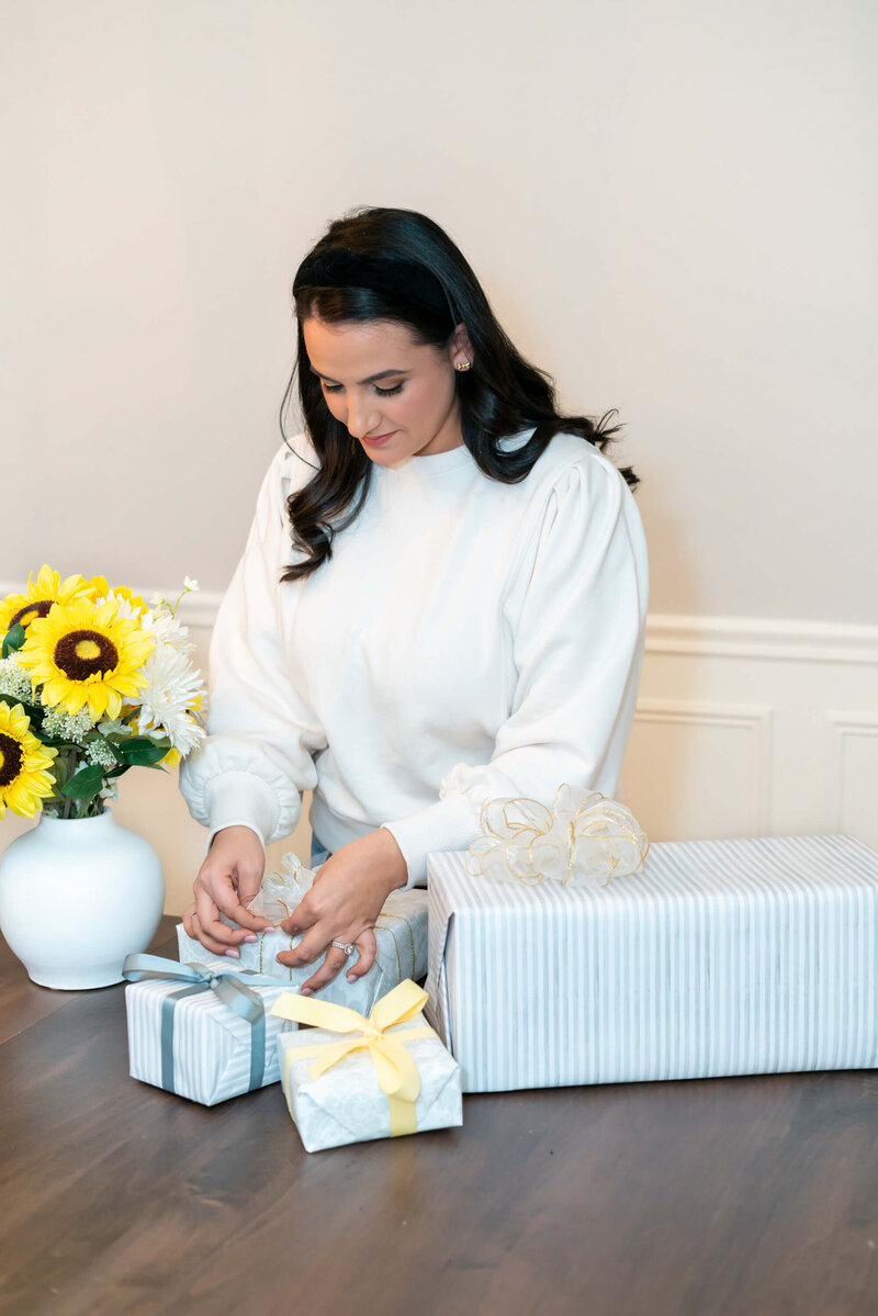 Aubrey of Graciously Gifted Tying a Bow on Gift Box