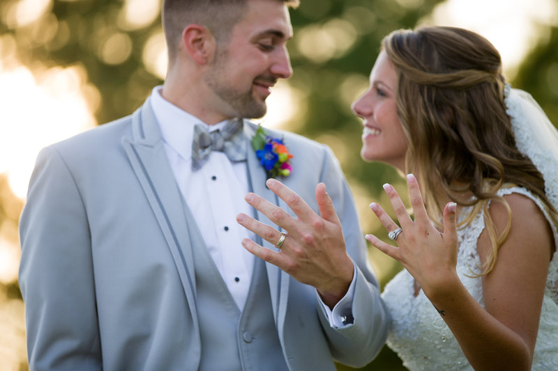 Bride and groom showing off their new wedding rings, capturing a fun and celebratory elopement moment.