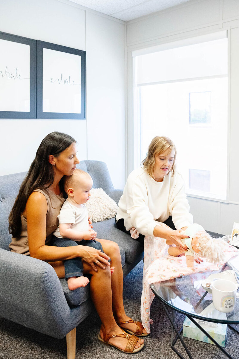 Teaching mom how to swaddle baby