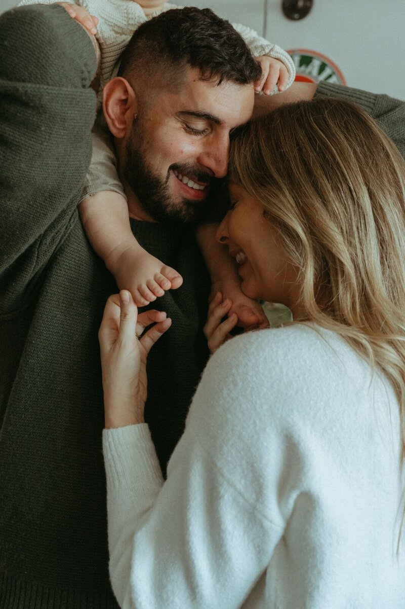 couple holding their son during family photos captured by NYC family photographer Elsie Goodman