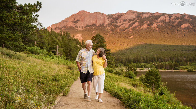 Couple walks along an easy path at Rocky Mountain National Park at sunset during summer