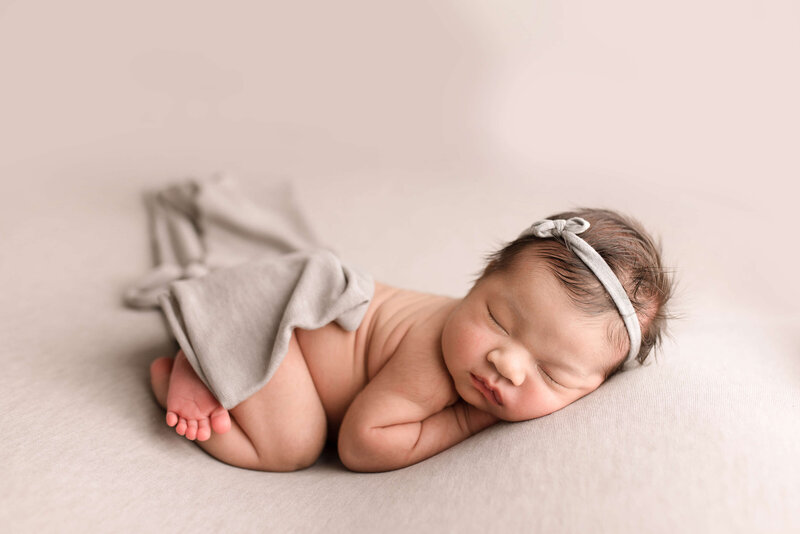 Baby girl on gray  fabric posed in Seattle studio
