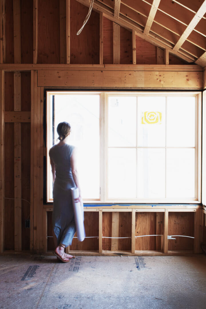 Sarah Scales on-site at a new construction beach house, designing a coastal home with a balance of modern and timeless interiors.