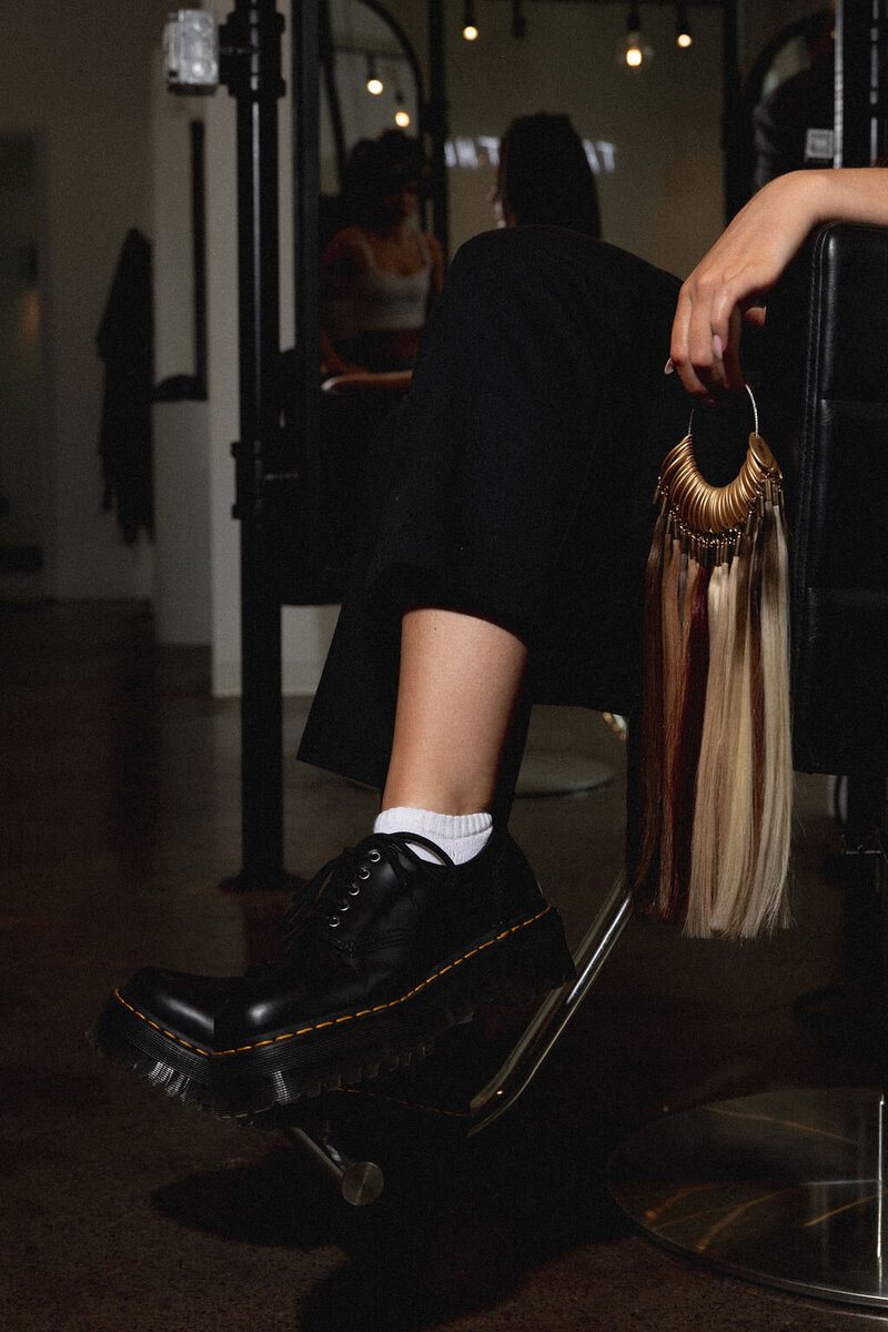 Black and white photo of Amelia Waters on the phone, representing the approachable, hands-on nature of Sunday Social Collective