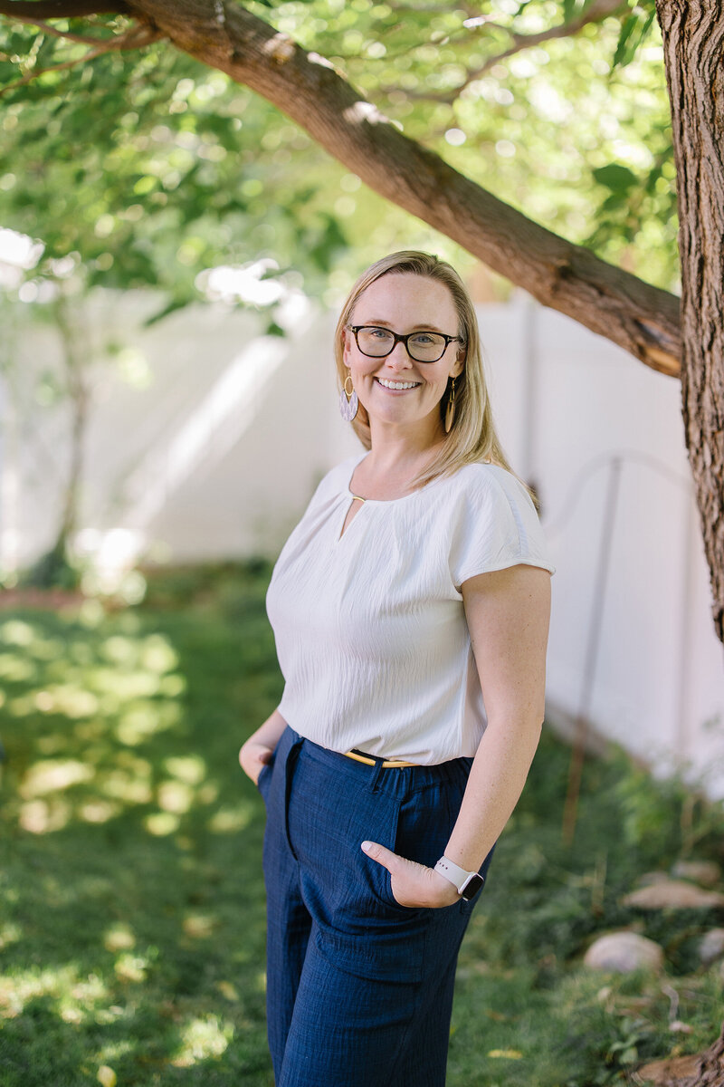 Headshot for Kim Kussman, Utah Realtor and Owner of Nurture Lane Realty, outside at a property.