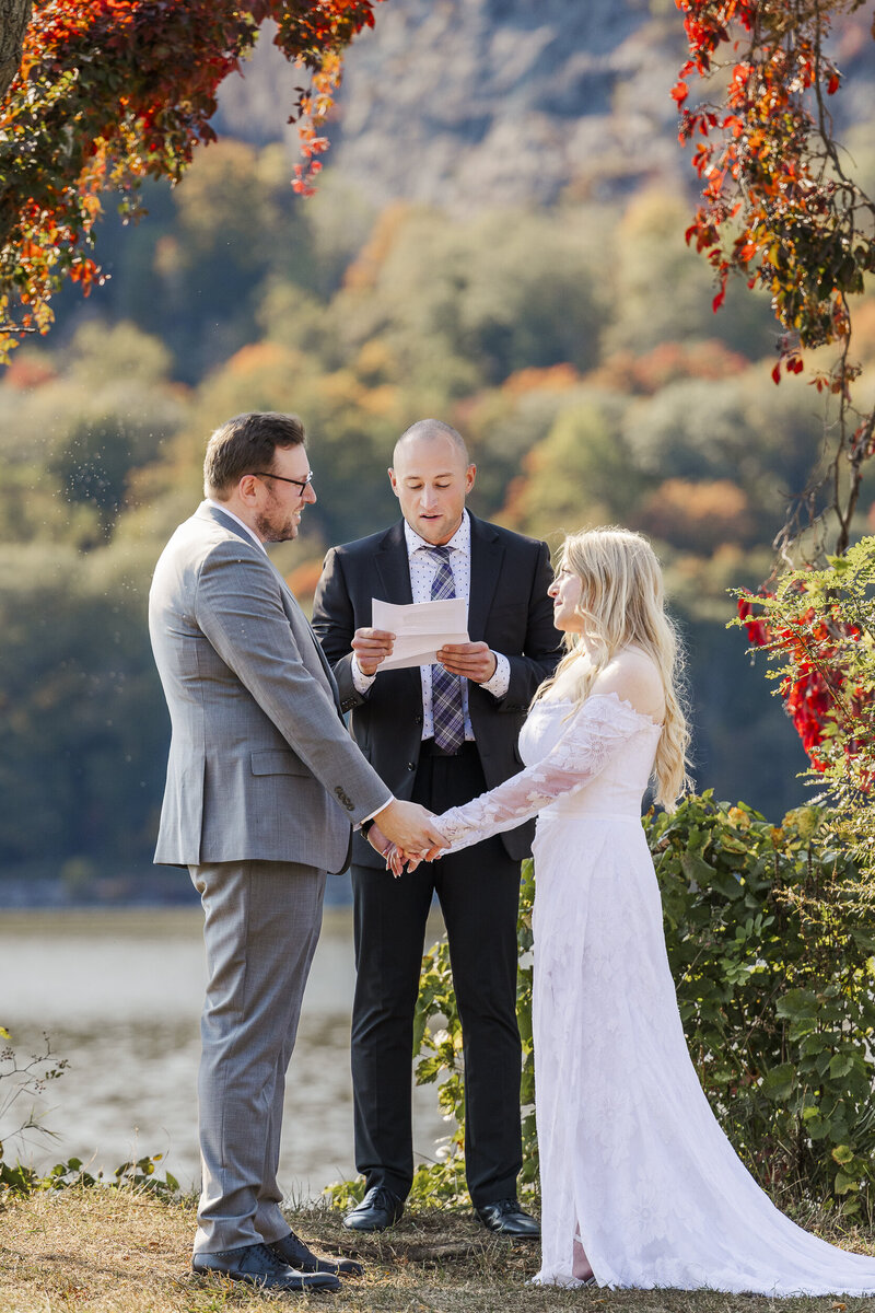 Hudson Valley elopement photographers capturing a fall riverside ceremony