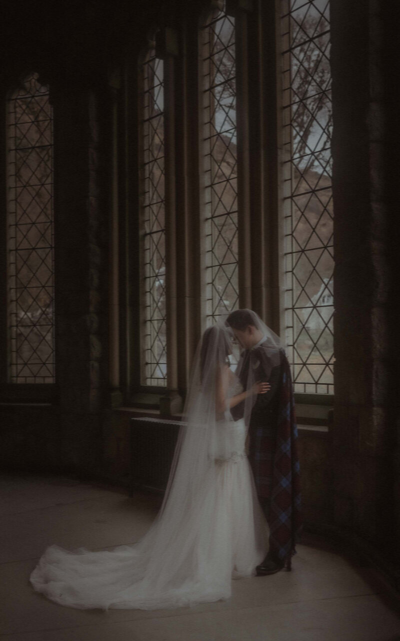 Married couple standing together in St. Kirk Church, sharing a heartfelt moment as they celebrate their love in a beautiful and historic setting