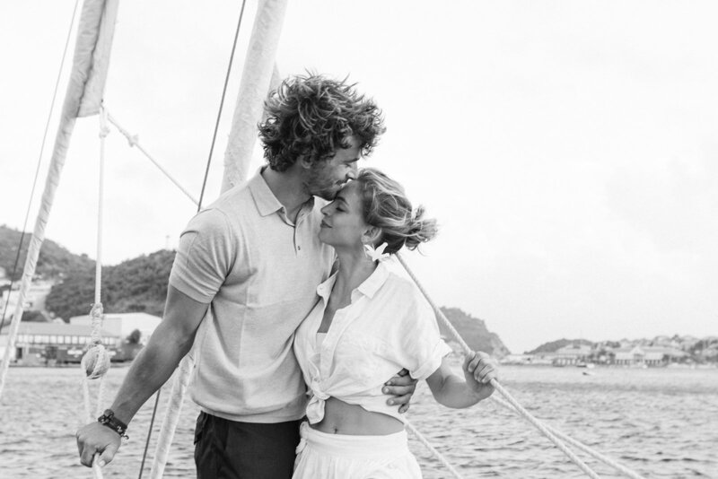 husband embracing wife on a boat in St Barths