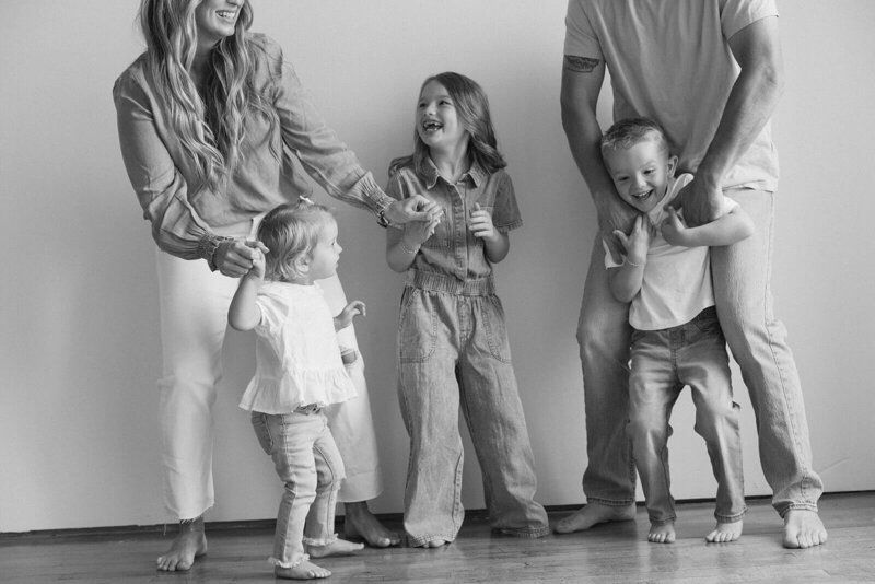 Sweet family of five dances on studio floor