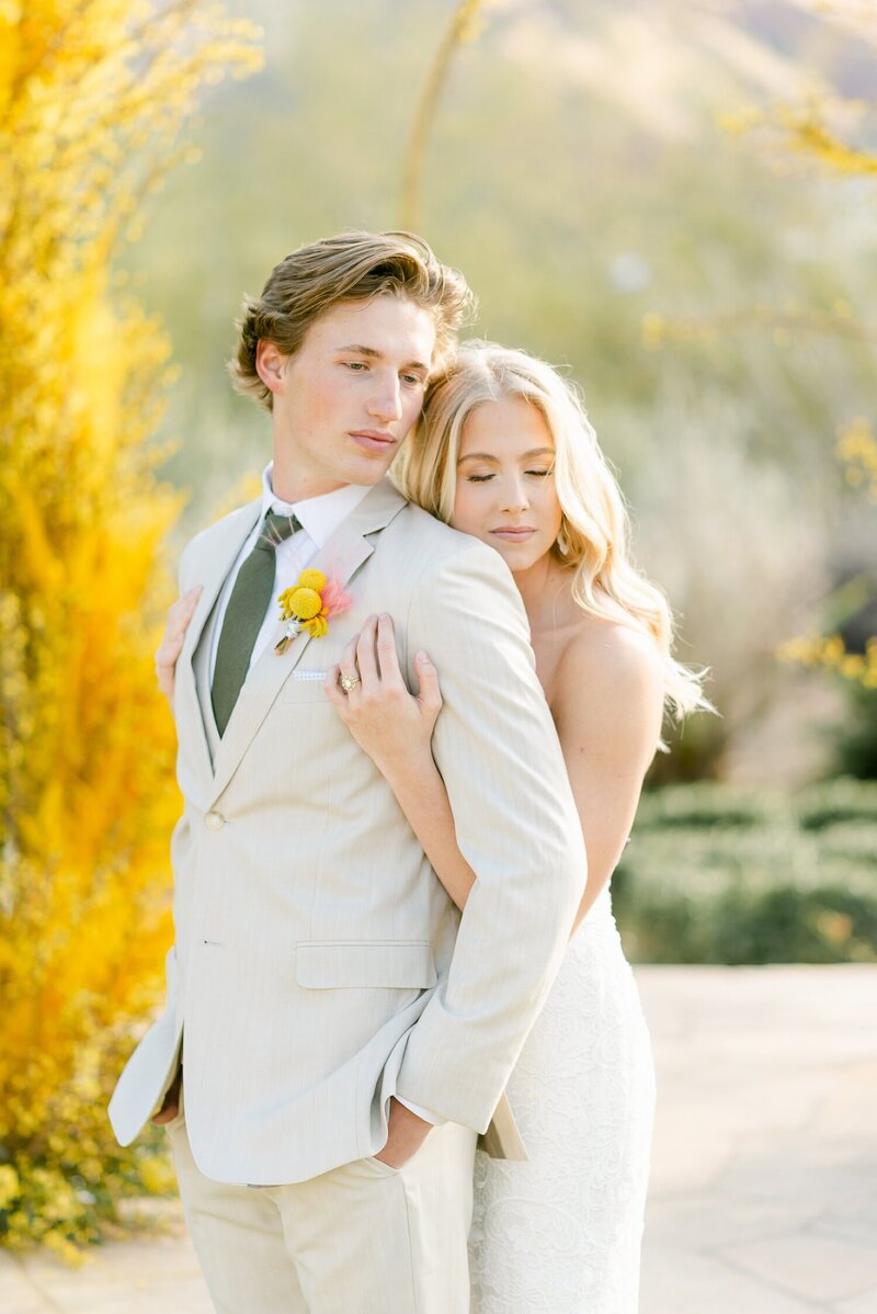 couple kissing in the trees with sunlight peeking through