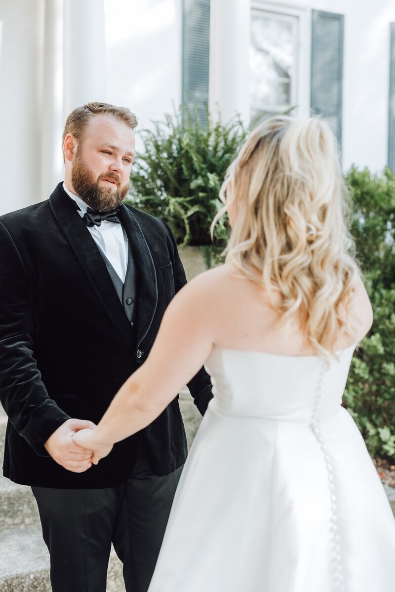 Bride and groom holding hands while starring at each other
