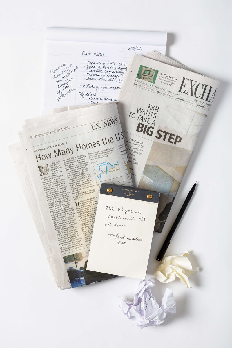 Nickie Kehoe smiling, seated in a green chair, wearing a white blazer.