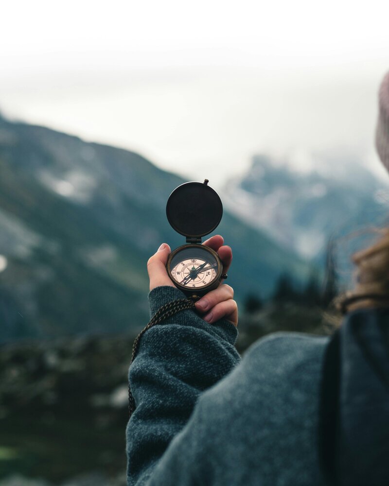 Person holding a compass representing ketamine therapy journey