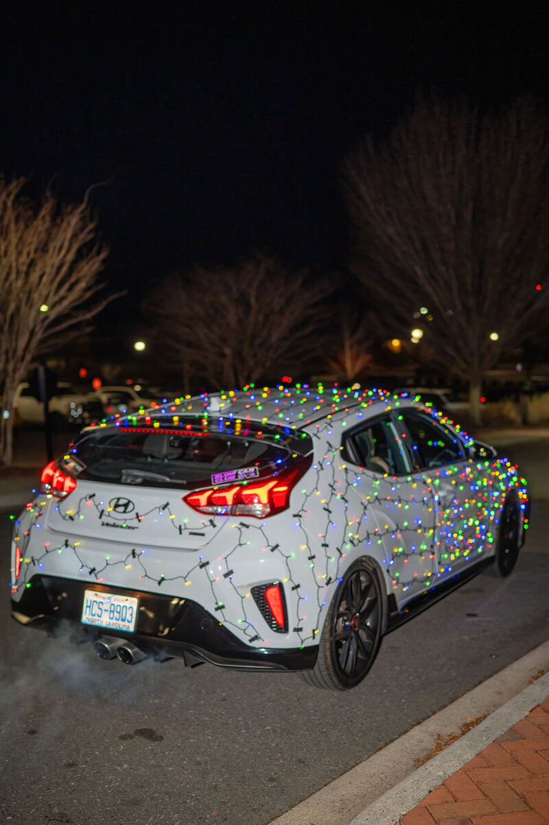 Wedding exit car wrapped in colorful lights