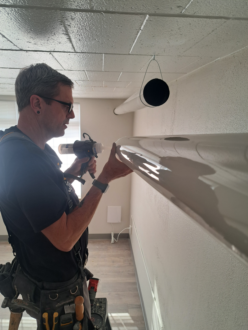 Remodel crew working on pipe