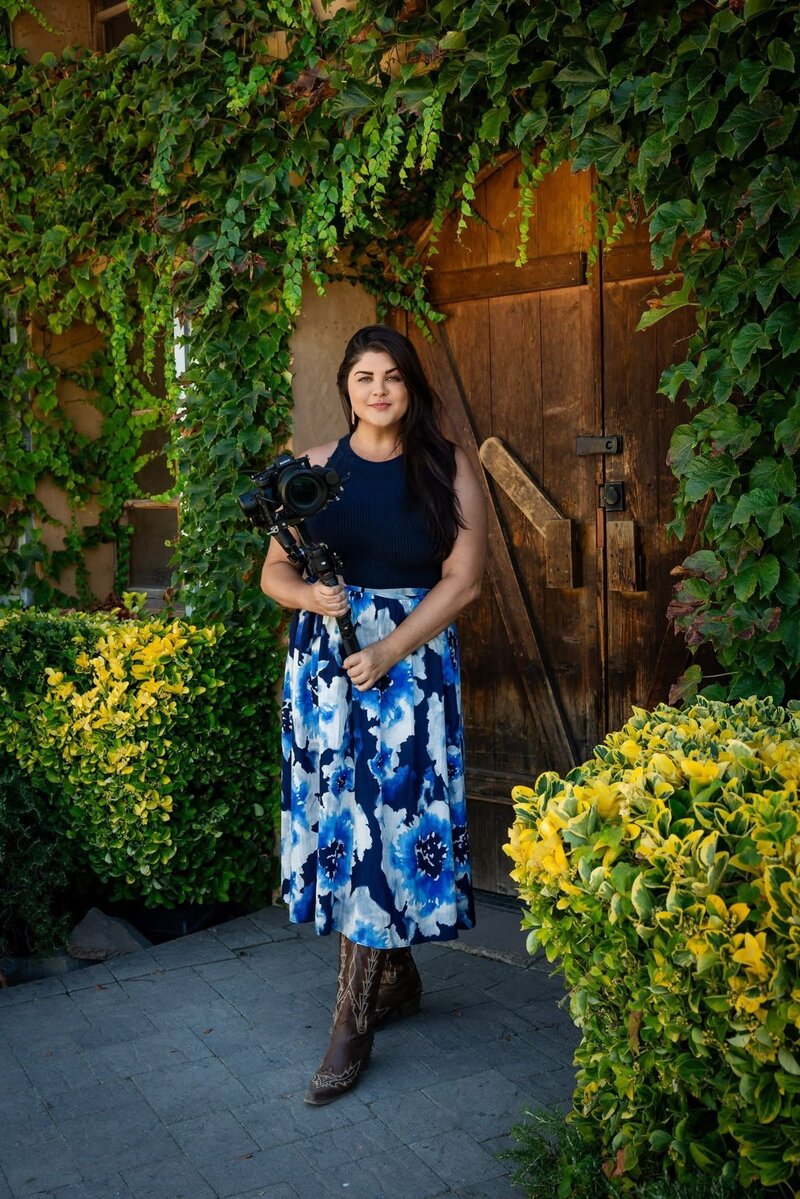 Delaney Mattson, Creative Director of Night Flight Media House, standing with her camera in hand—embodying passion and artistry in brand storytelling.