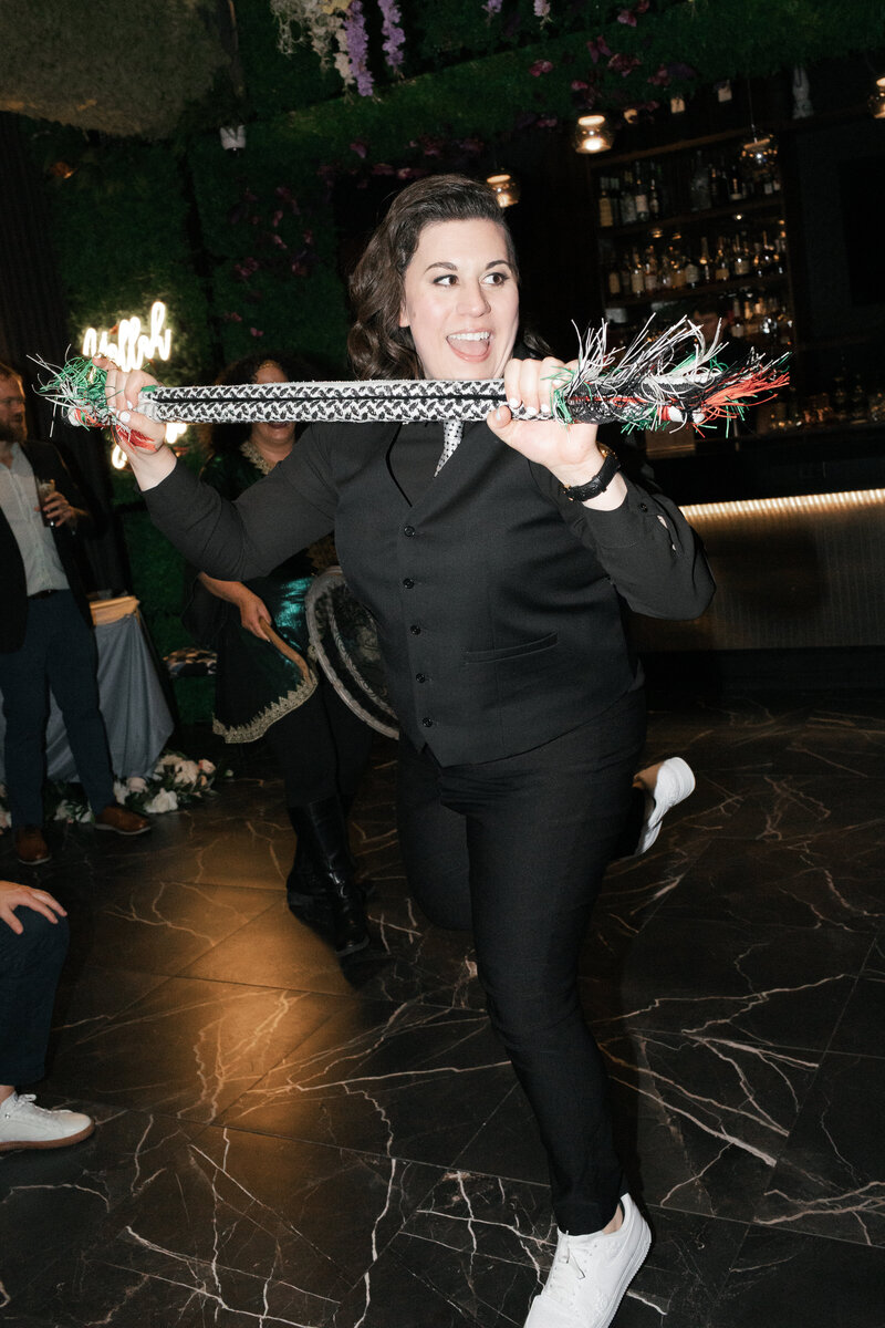 lesbian bride doing a traditional Palestinian dance on the dance floor