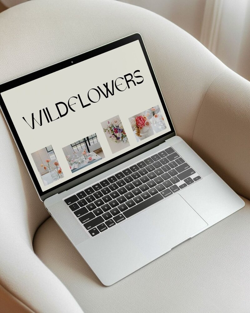 laptop on a white boucle chair with a website home page design