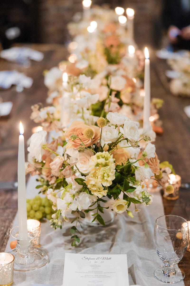 Romantic candlelit wedding tablescape with pastel luxury florals at an elegant Philadelphia reception