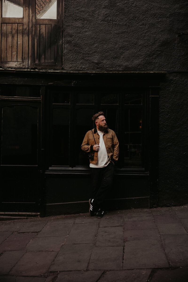 Creative Photographer Mark Horton sits for outside a coffee shop in Soho London.