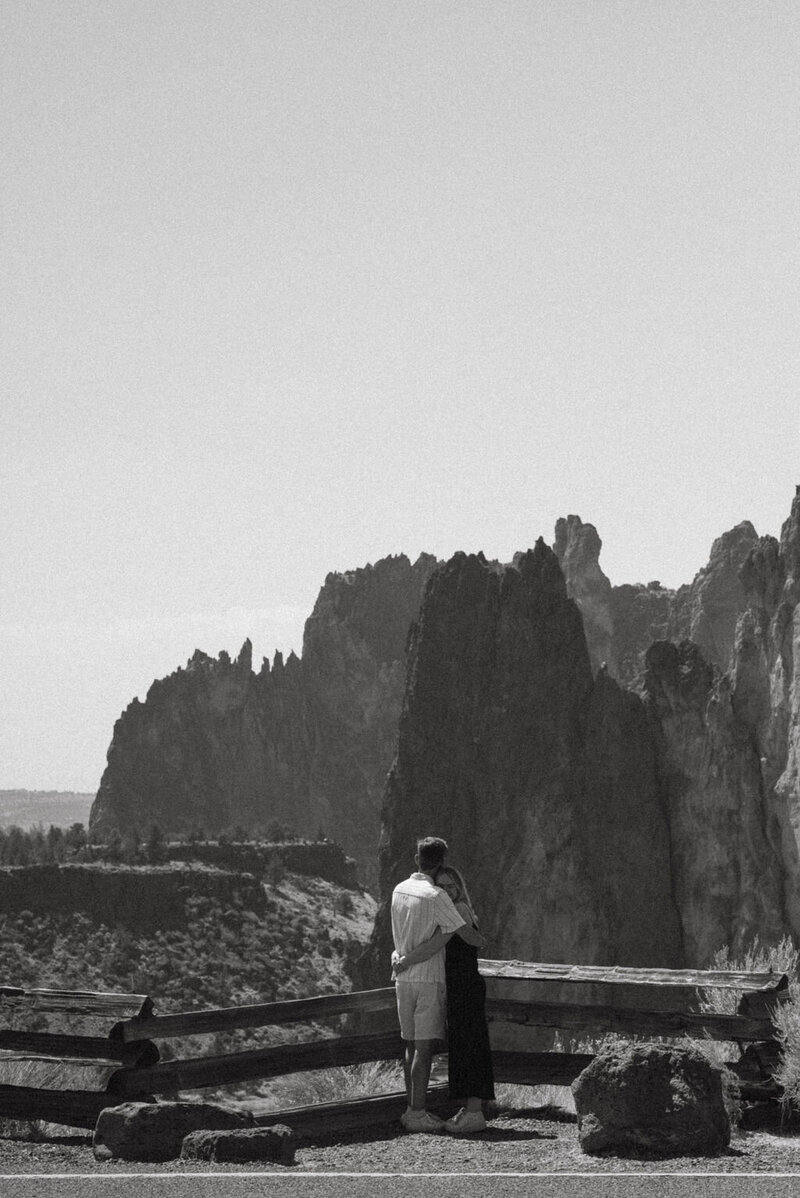 Couple's portrait session at Smith Rock State Park in Oregon, featuring stunning natural rock formations and scenic views. Intimate engagement photoshoot with love and adventure in a breathtaking outdoor setting.