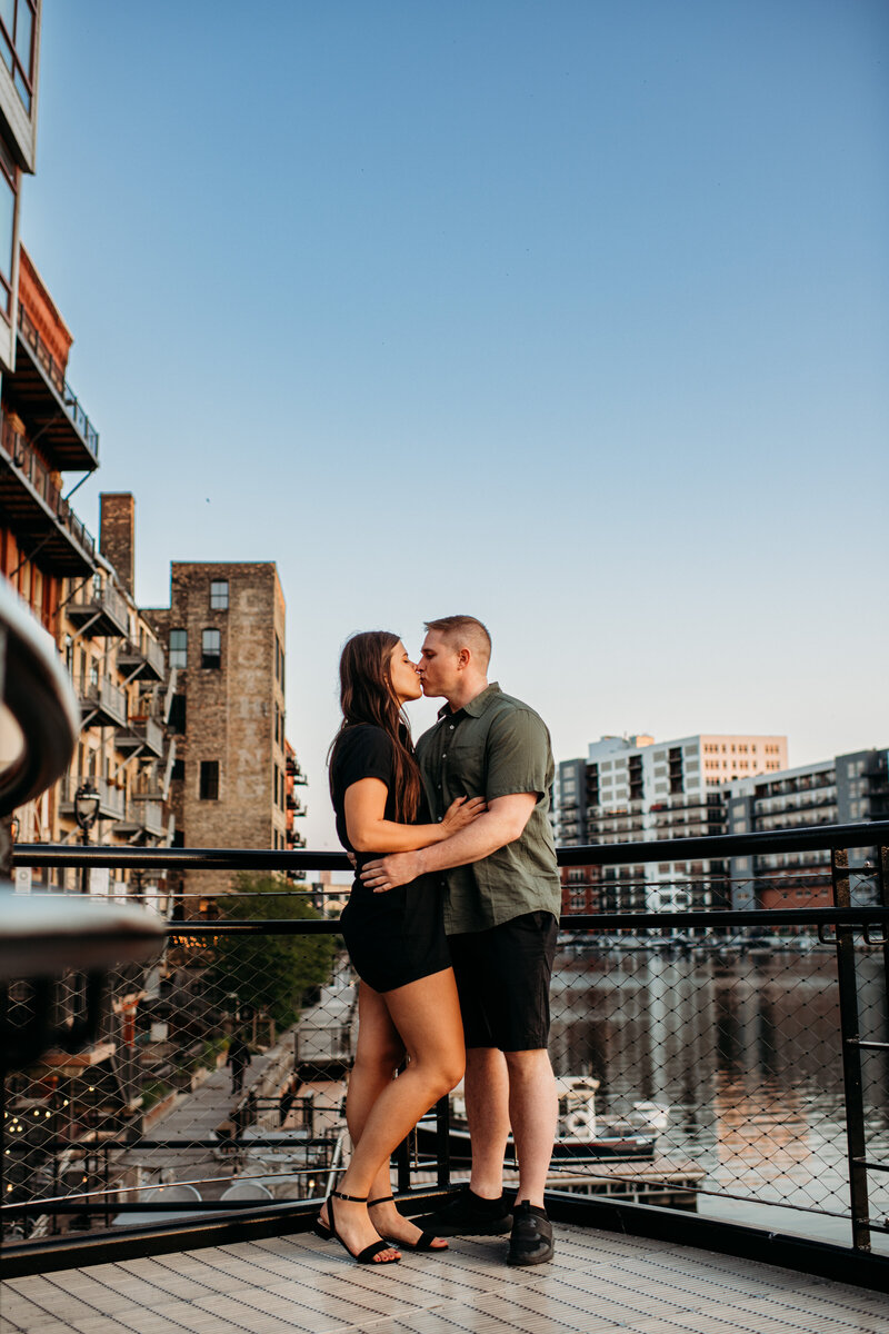 Man and woman embracing each other in front of Milwaukee skyline