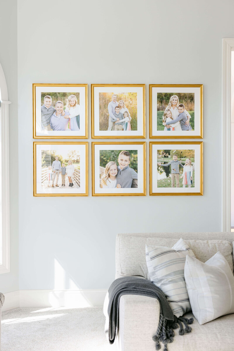 gallery wall featuring 6 gold framed portraits of a family