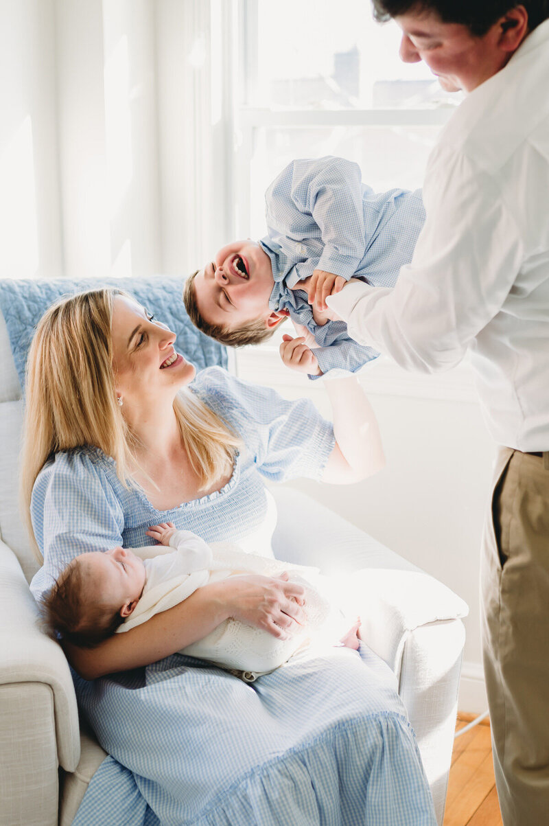 mom and dad playing with baby and little boy