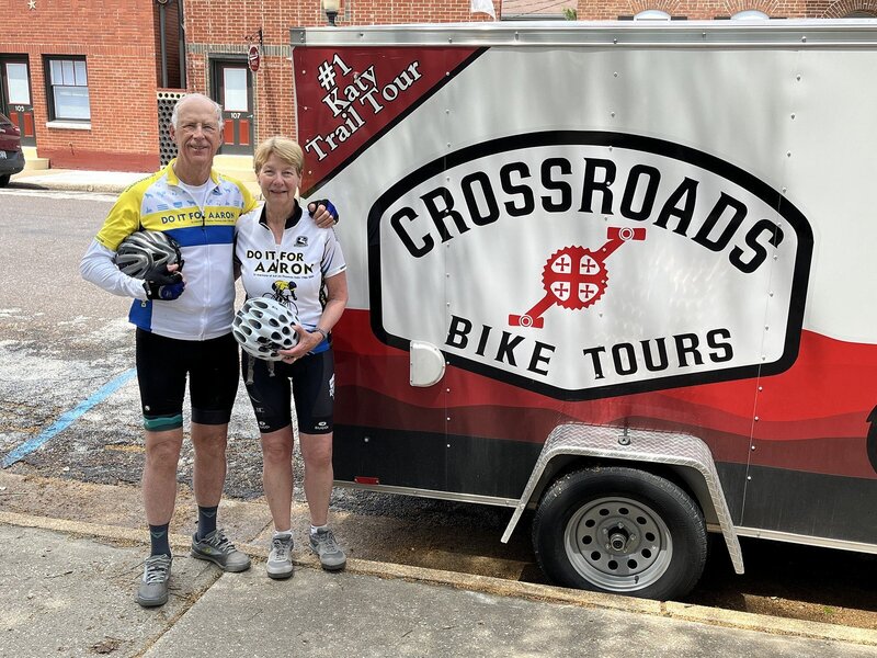 Couple riding the katy trail with corss roads bike tours trailer along bike trail