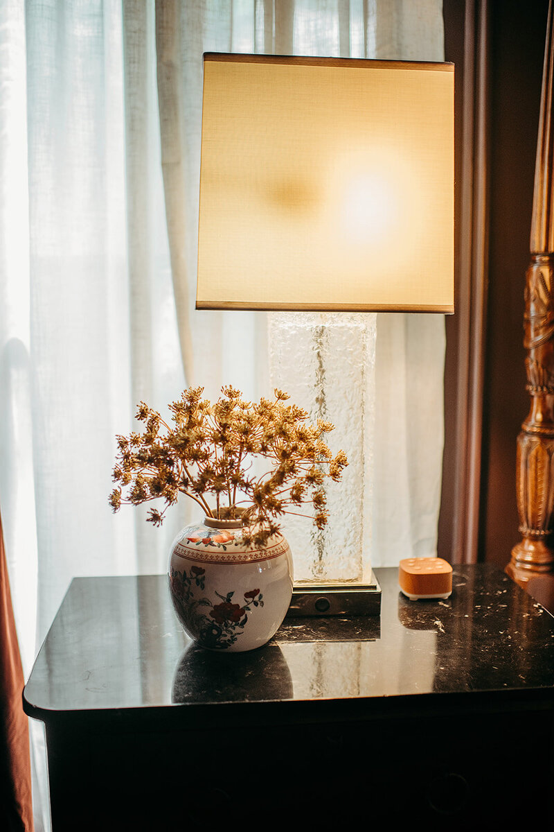 House-dried florals sit atop the bedside table