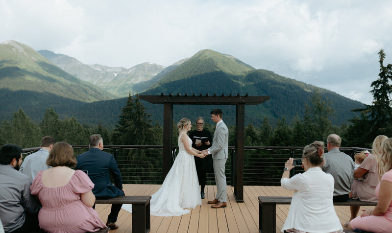 A couple holding hands and exchanging vows.