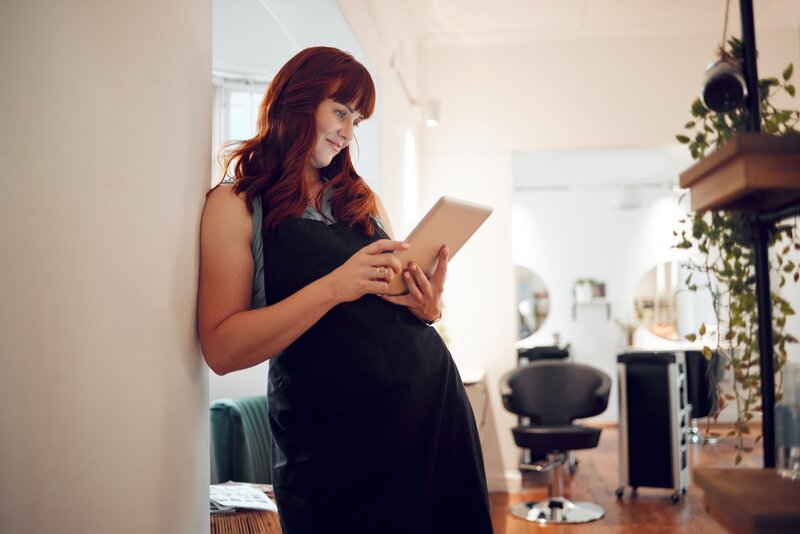 Citizen Salon owner reviewing financial reports with RaeAnn Stout in Oceanside, seeing the results of organized bookkeeping