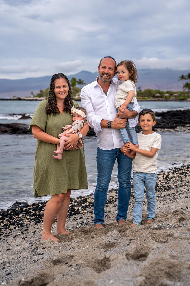 Family standing on beach taken by hawaii family photographer
