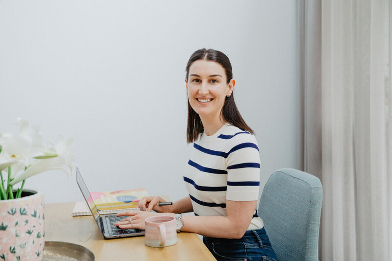 Nutritionist in perth sitting on couch