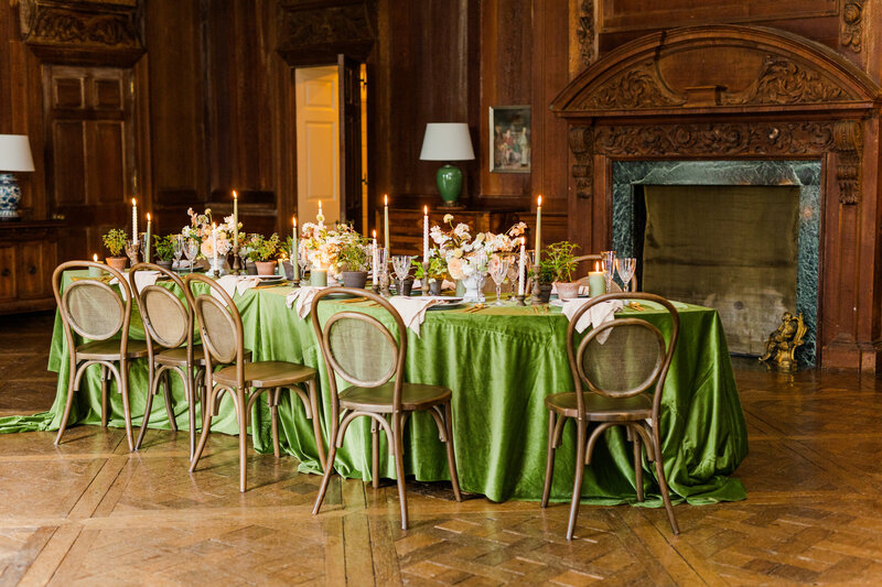 Luxury reception table setting with silk table cloth , beautiful floral arrangements and candles