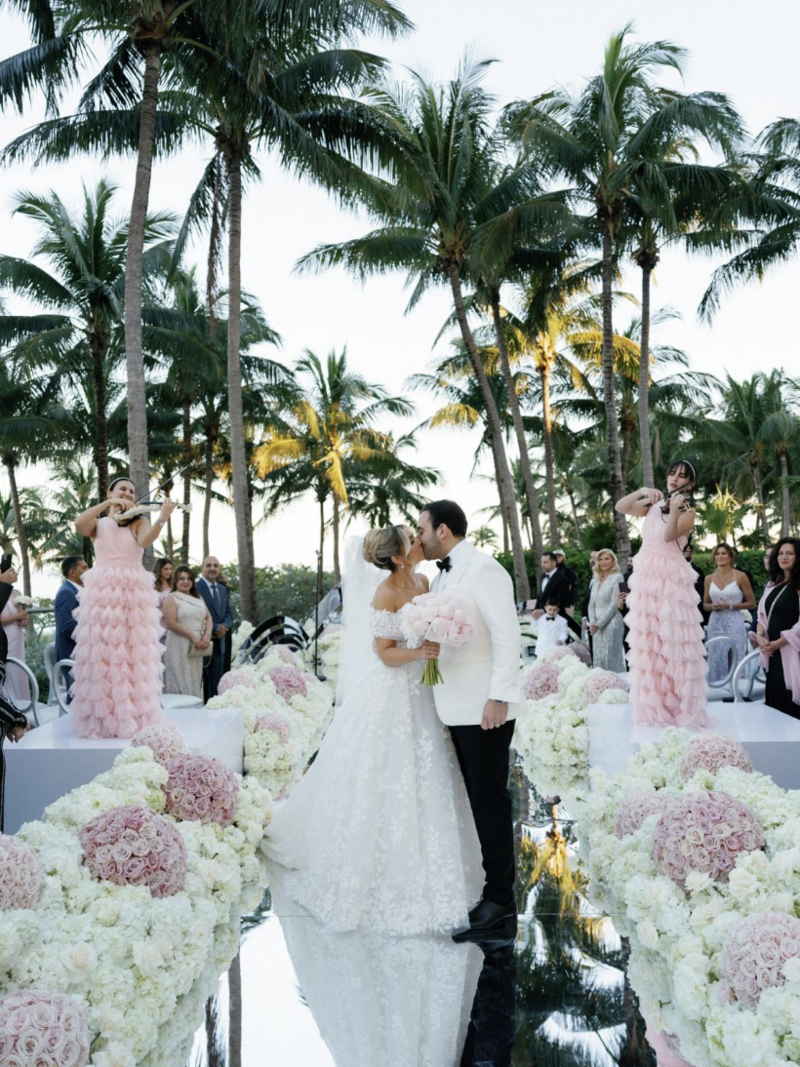bride and groom holding hands