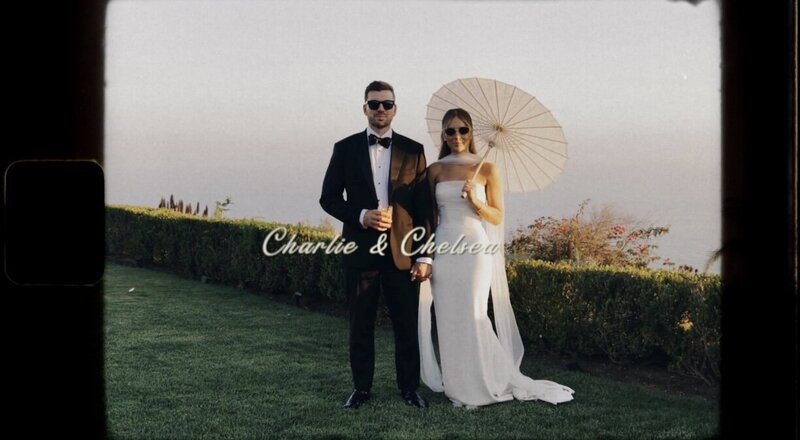 still from arizona wedding video couple holding hands posing next to cacti