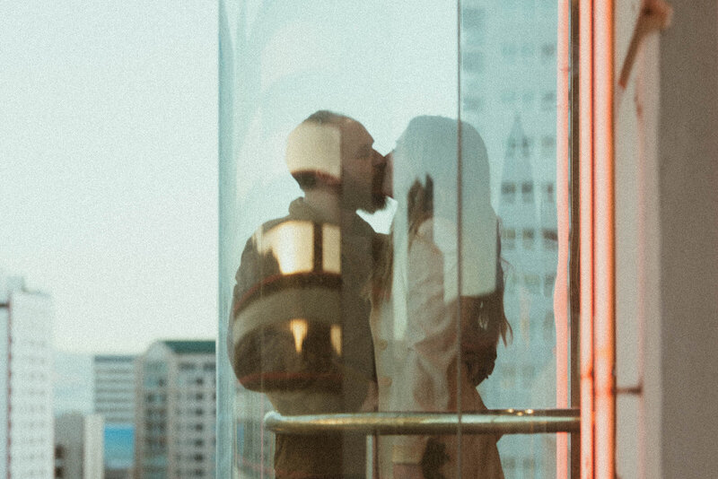 man and woman kissing in elevator